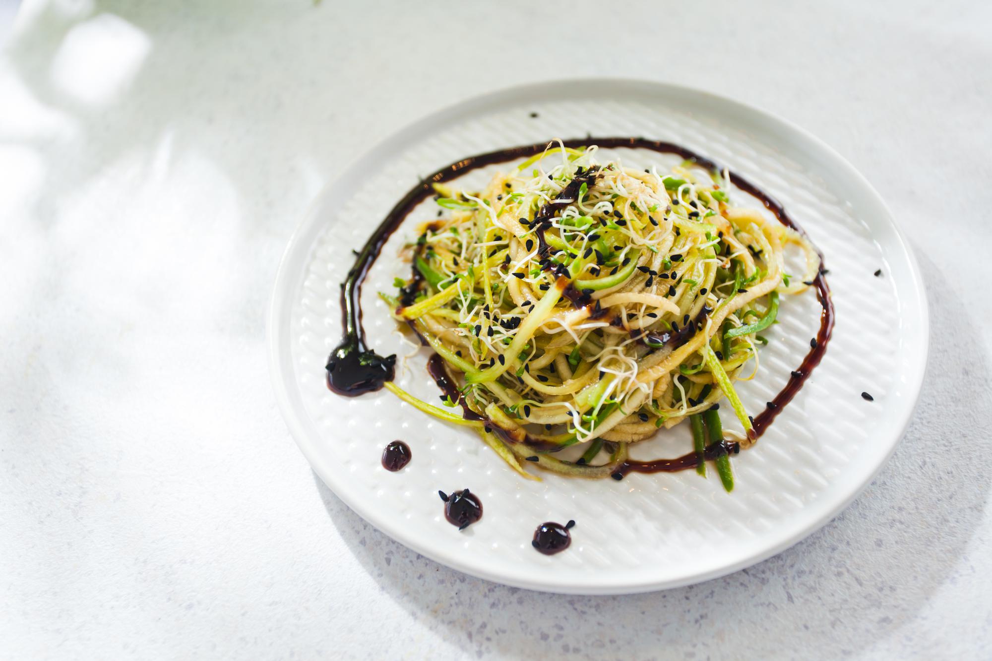 Close-up of plated gourmet starter with gold accents